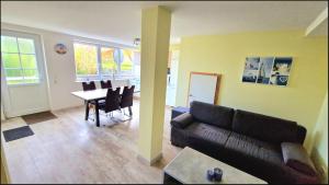 a living room with a couch and a table at Seeblick in Hohenfelde