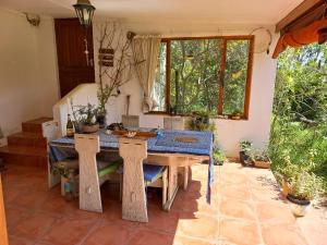a dining room with a table and some plants at Bird cottage in Barrydale