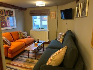 a living room with a couch and a table at The Old Post Office in Bridgnorth