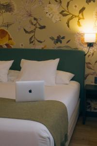 a bedroom with a bed with a laptop on it at Hotel Director Vitacura in Santiago +26 photos