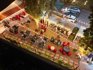 an overhead view of a patio with tables and chairs at night at Umai Garden Resort in Jogīkuti