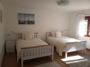 a bedroom with two beds and a window at Bellevue Josselin 1a Chemin des Cruyere in Josselin