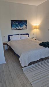 a bedroom with a bed and a table and a lamp at Vedo apartment 3 Тячів in Tyachiv