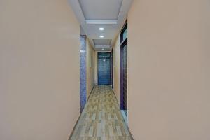 an empty corridor in a building with a hallway at FabHotel HM Inn in Lucknow