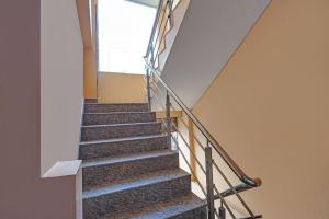 a staircase in a building with metal railing at FabHotel HM Inn in Lucknow