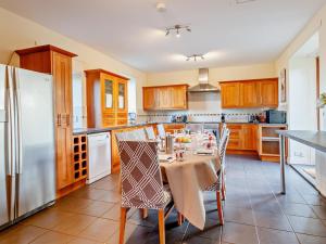 a kitchen with a table with chairs and a refrigerator at 7 Bed in Cupar oc-81242 in Cupar