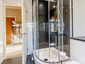 a shower with a glass door in a bathroom at 7 Bed in Cupar oc-81242 in Cupar +36 photos