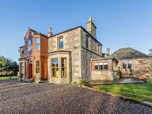 a large brick house with a driveway at 7 Bed in Cupar oc-81242 in Cupar