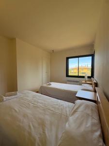 a bedroom with two beds and a window at Villa Torremirona Resort Palmeras in Navata +19 photos