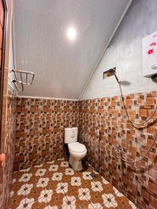 a bathroom with a toilet and a shower at DIENG CAKRAWALA CABIN Tambi Syariah in Kejajar +27 photos