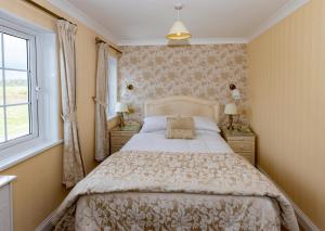 a bedroom with a large bed and a window at Haddon House Hotel in Bridport