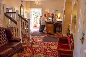 a group of people standing in a hallway at Haddon House Hotel in Bridport