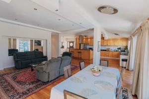 a living room with a table and a kitchen at Grande Hotel in Cape Town