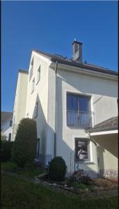 a white house with a window and a balcony at Staar in Hohenfelde