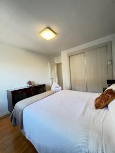 a bedroom with a white bed and a dresser at Dalí City Apartamento in Figueres +12 photos
