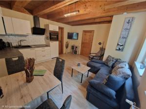 a living room with a couch and a table at Staar in Hohenfelde +11 photos