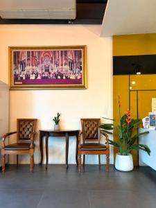 a dining room with two chairs and a table at Thongmanee Hotel in Hat Yai