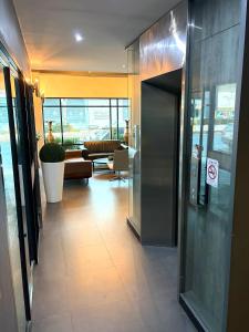 a hallway of a building with a waiting room at Thongmanee Hotel in Hat Yai