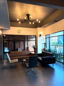 a living room with a couch and a table at Thongmanee Hotel in Hat Yai