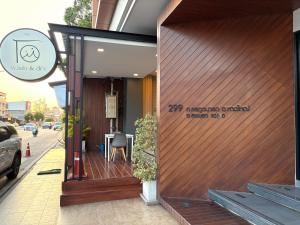 a building with a wooden door with a table on the sidewalk at Thongmanee Hotel in Hat Yai