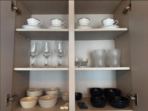 a shelf filled with glasses and plates and bowls at Fresh Stay in Seoul