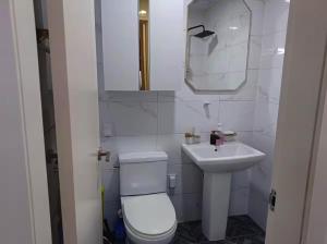a white bathroom with a toilet and a sink at Fresh Stay in Seoul +25 photos