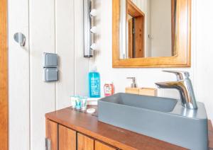 a bathroom with a sink and a mirror at La Maison du Bonheur au Coeur d'Etretat in Étretat