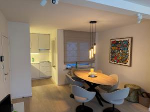 a kitchen and dining room with a table and chairs at Cosy Seahouse in Knokke-Heist