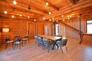 a dining room with a table and chairs at Wooden villa with superpool and sauna, 30 min from Yerevan in Tsakhkashen