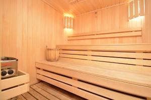 a sauna with wood paneling and a wooden floor at Wooden villa with superpool and sauna, 30 min from Yerevan in Tsakhkashen