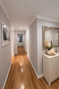 a hallway of a home with white walls and wood floors at Cosy and Secure Suite Marbella Center in Marbella