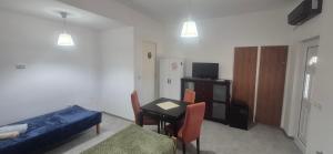 a living room with a bed and a table and a room with a couch at Odmorište Noćko in Valjevo