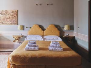 a bedroom with a bed with two pillows on it at Hotel I Portici in Arezzo