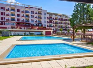 a swimming pool in front of a building at Spa Valley II experiences Penthouse con Piscina climatizada y Yacuzzi in Villanueva de Río Segura