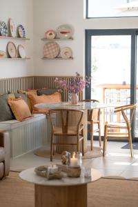a living room with a table and a couch at Sout Huijs Langebaan with hot tub in Langebaan