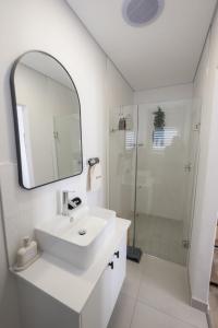 a white bathroom with a sink and a shower at Sout Huijs Langebaan with hot tub in Langebaan +24 photos
