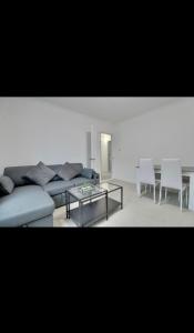 a living room with a couch and a table and chairs at Flat in Portsmouth in Portsmouth