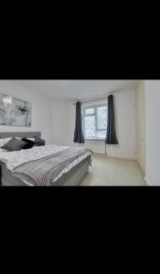 a bedroom with a large bed and a window at Flat in Portsmouth in Portsmouth