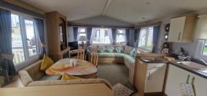 a living room with a couch and a table at Bewles Caravan in Rhyl