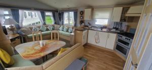 a small kitchen and living room in a rv at Bewles Caravan in Rhyl +37 photos