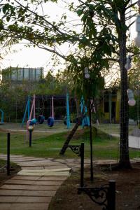 a park with a playground with a swing at Touchwood Bliss Nature Retreat - Igatpuri in Igatpuri