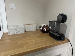 a kitchen counter with a hair dryer and a box at Modern 2 Bed Apartment, Sleeps 4 in Bolton