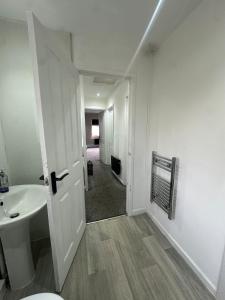 a white bathroom with a sink and a toilet at Modern 2 Bed Apartment, Sleeps 4 in Bolton