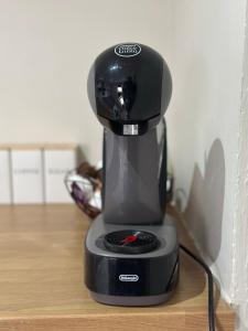 a black coffee maker sitting on top of a table at Modern 2 Bed Apartment, Sleeps 4 in Bolton +5 photos