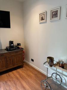 a living room with a tv on a wall at Snow&Rose in Damme