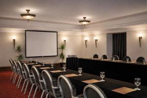 a conference room with a table and chairs and a screen at Sheraton Khalidiya Hotel in Abu Dhabi +57 photos