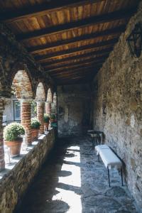 a hallway with a bench in a stone building at Eremo della Maddalena the oasis of the 5Terre in Monterosso al Mare