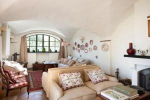a living room with a couch and a fireplace at Eremo della Maddalena the oasis of the 5Terre in Monterosso al Mare