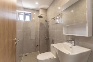 a bathroom with a shower and a toilet and a sink at Tidal Mist Homestay in Long Hai +16 photos