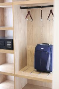 a suitcase sitting on a shelf in a closet at Zoe Boutique Hotel in Durrës